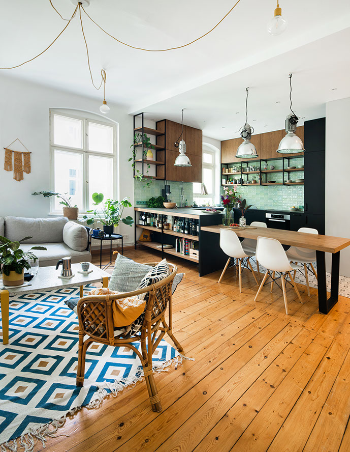 Modern kitchen with green tile backsplash and wooden open shelving.