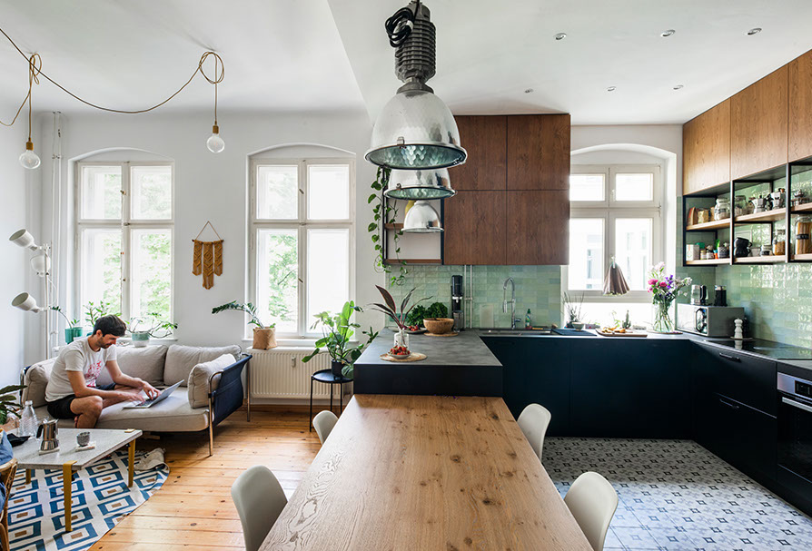 Modern kitchen with green tile backsplash and wooden open shelving.